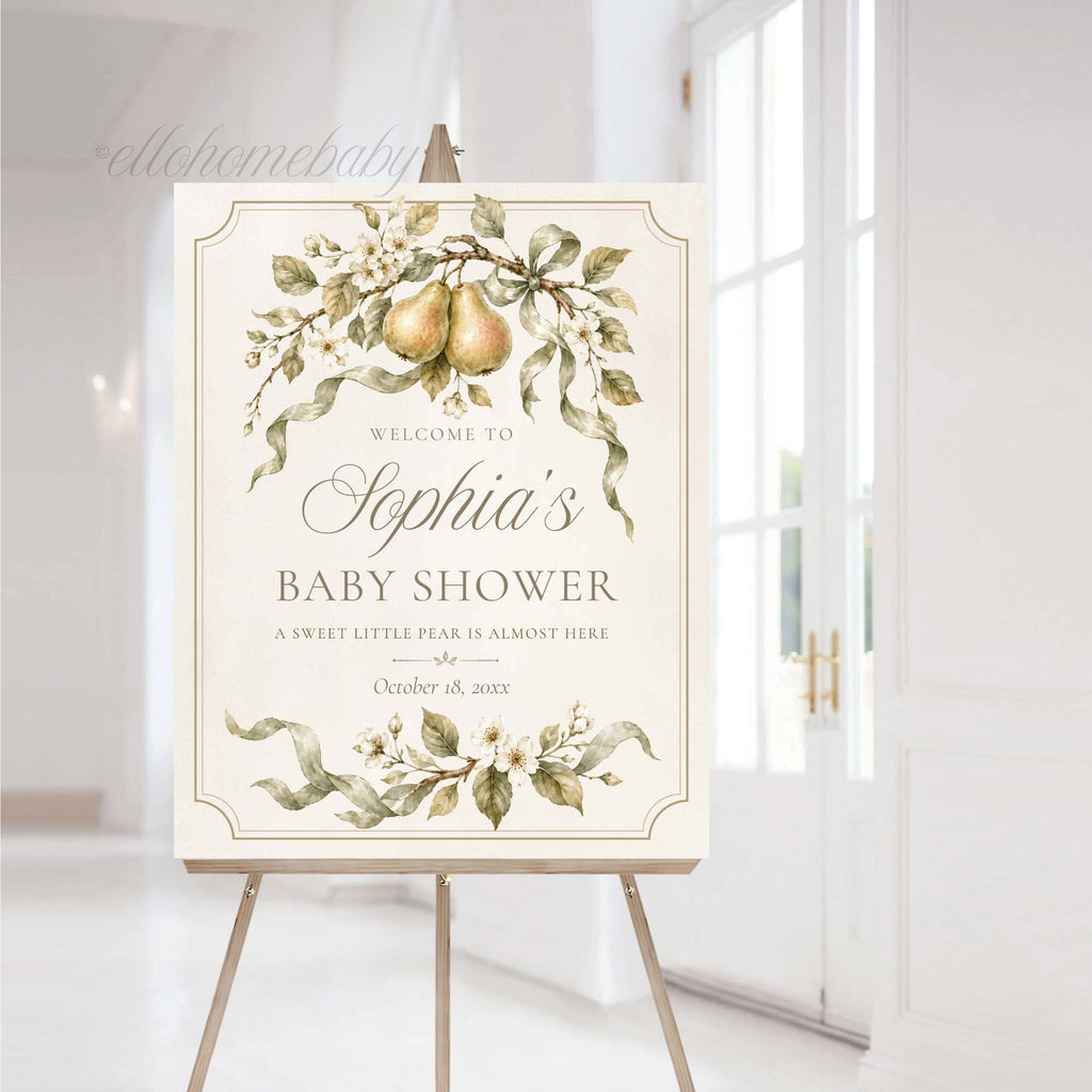 Elegant pear-themed baby shower sign displayed on an easel in a bright neutral event space.