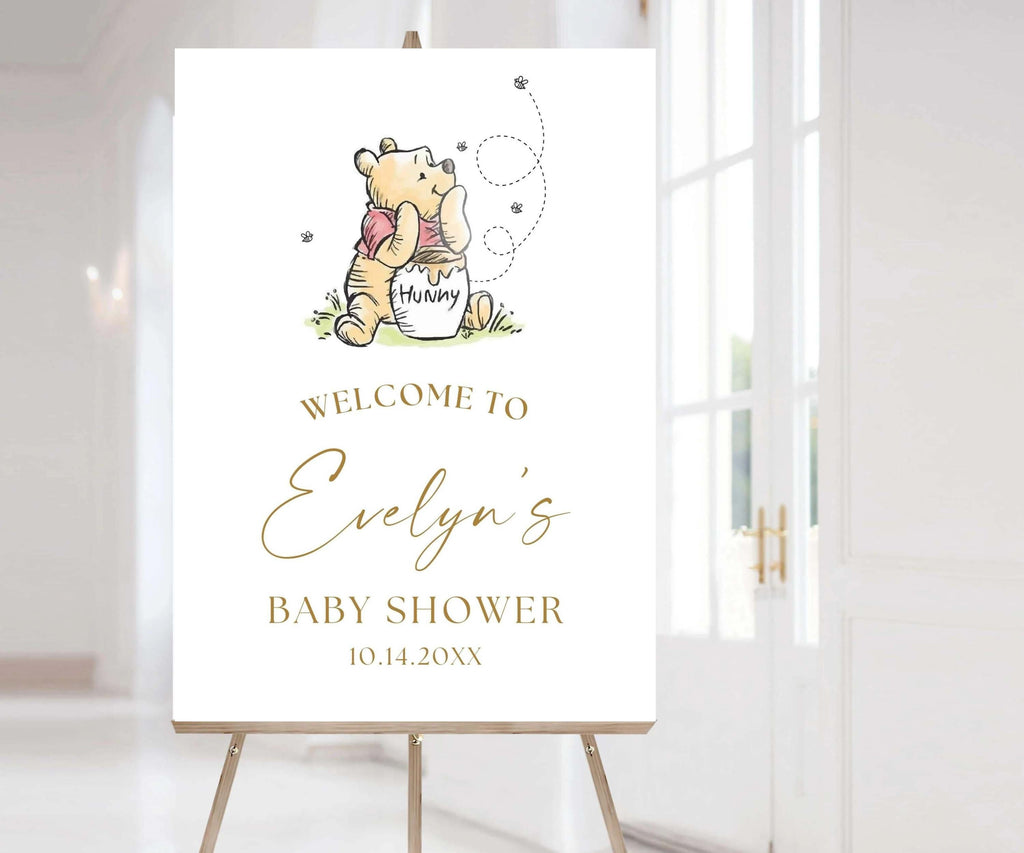 May include: A Winnie the Pooh themed baby shower welcome sign with a cartoon illustration of Winnie the Pooh holding a honey pot. The sign says "Welcome to Evelyn's Baby Shower 10.14.20XX".