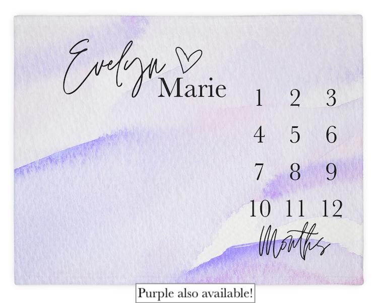 This elegant watercolor milestone blanket features a soft purple design with modern typography and a custom baby name, creating a keepsake you’ll treasure forever. Designed for both style and practicality, it makes monthly photo sessions effortless and beautiful.

✨ Available in TWO color options:
• Blush Pink
• Soft Purple
Perfect for baby girls, baby showers, baby sprinkle, newborn gifts, or expecting parents who love soft, modern nursery aesthetics.