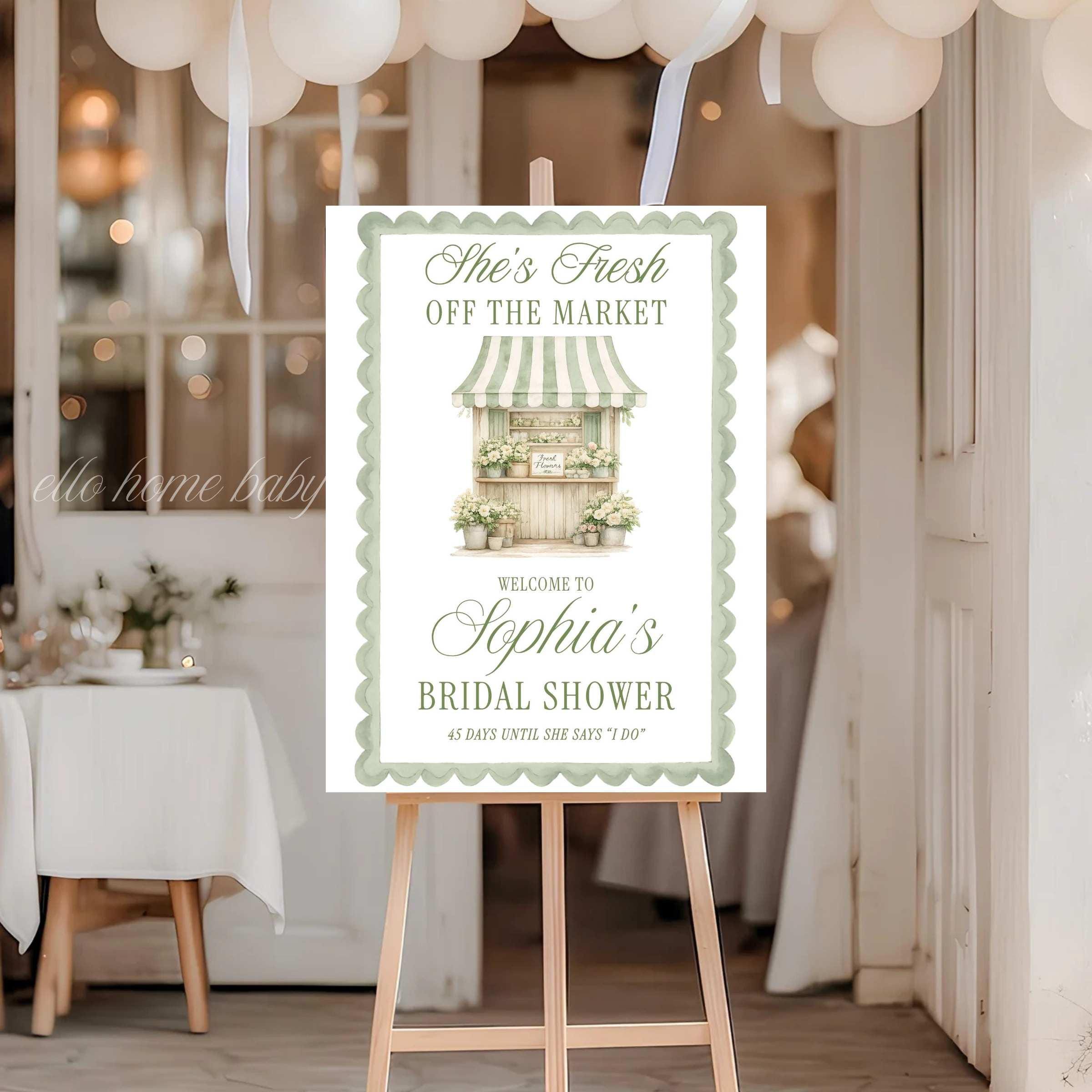 Farmers market themed bridal shower welcome sign printed on foam board with watercolor storefront illustration and personalized text. Sage green scalloped frame bridal shower entrance sign.