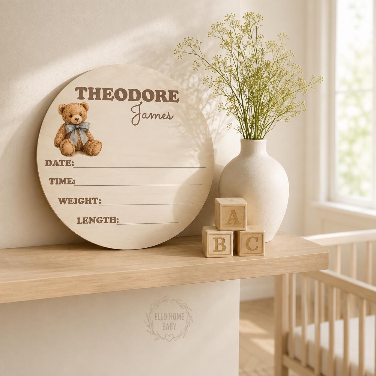 Matching round teddy bear birth-stat plaque displayed in nursery, available separately from milestone blanket.