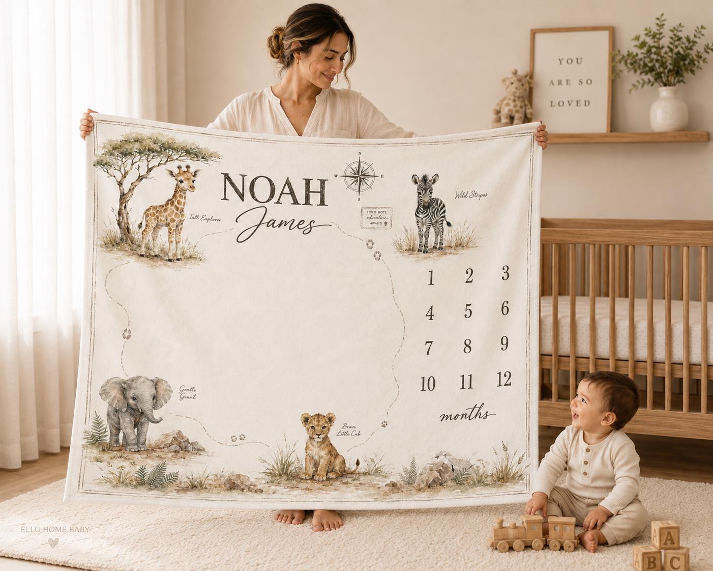 Mother holding a neutral safari map milestone blanket personalized with Noah James beside a baby in a warm modern nursery.