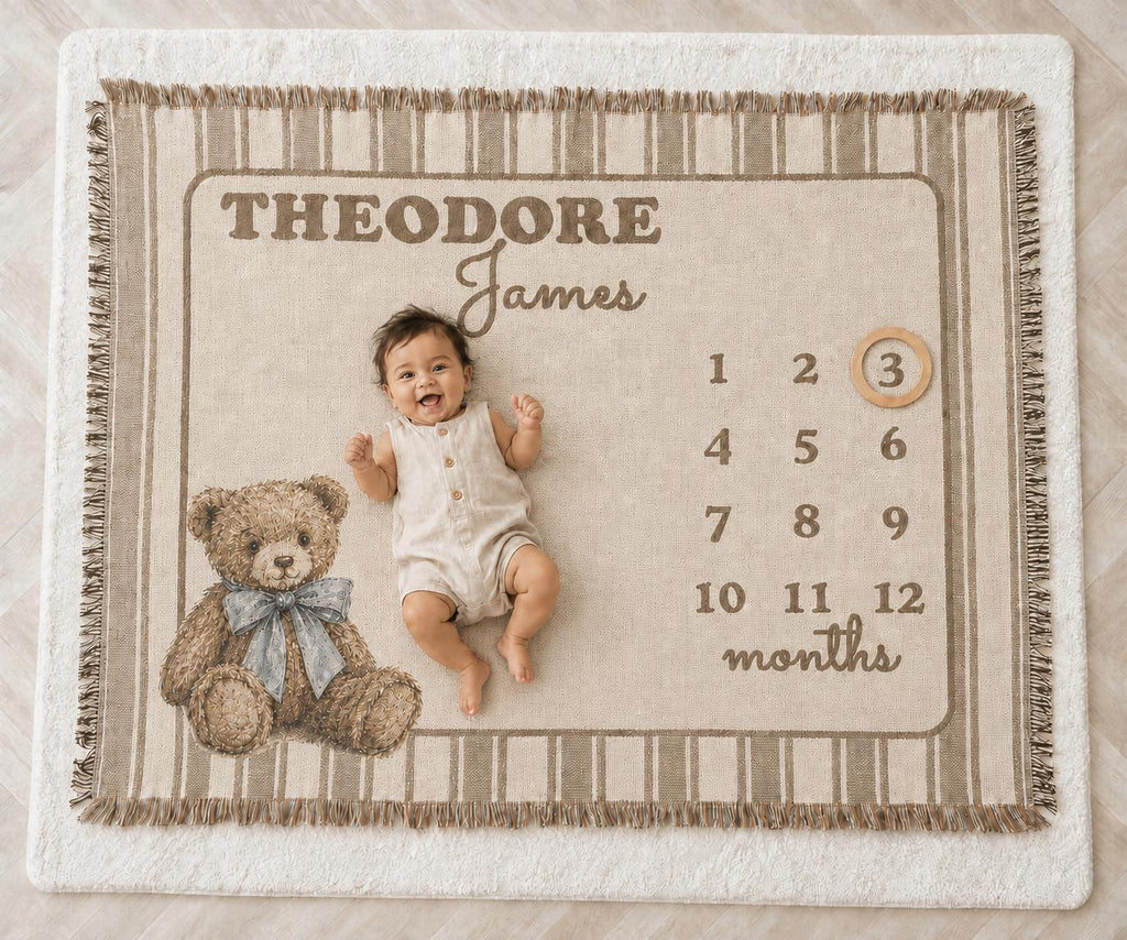 Personalized woven teddy bear milestone blanket with brown stripes, custom name and baby posed beside month three. Vintage Heirloom woven baby blanket.