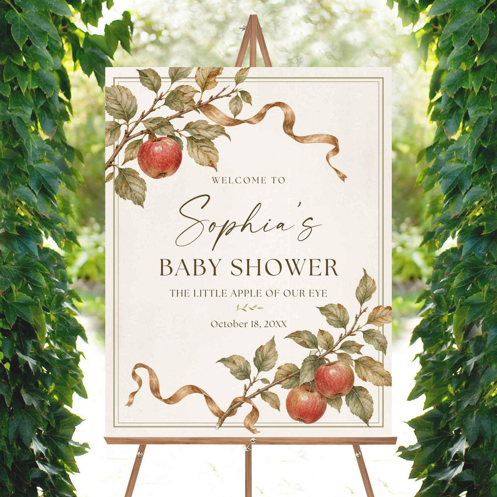 Close view of an heirloom watercolor apple shower sign with botanical branches, red apples and delicate double border.