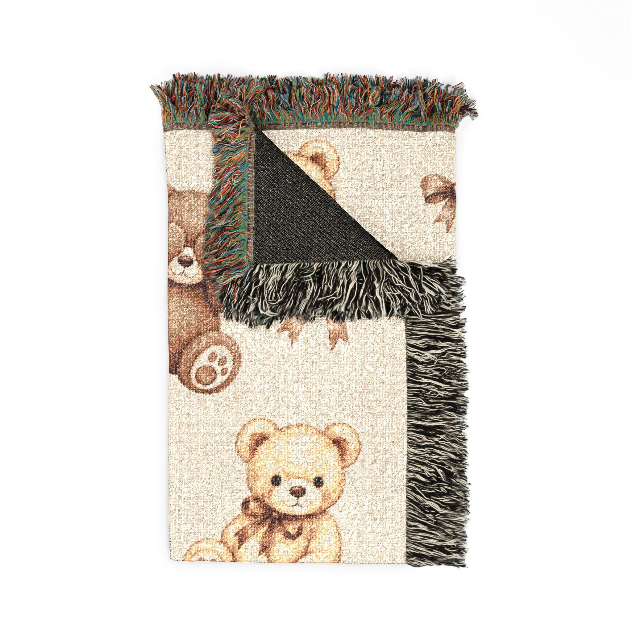 Folded personalized teddy bear woven blanket showing textured cotton yarn, warm neutral colors, custom baby name and decorative fringe.