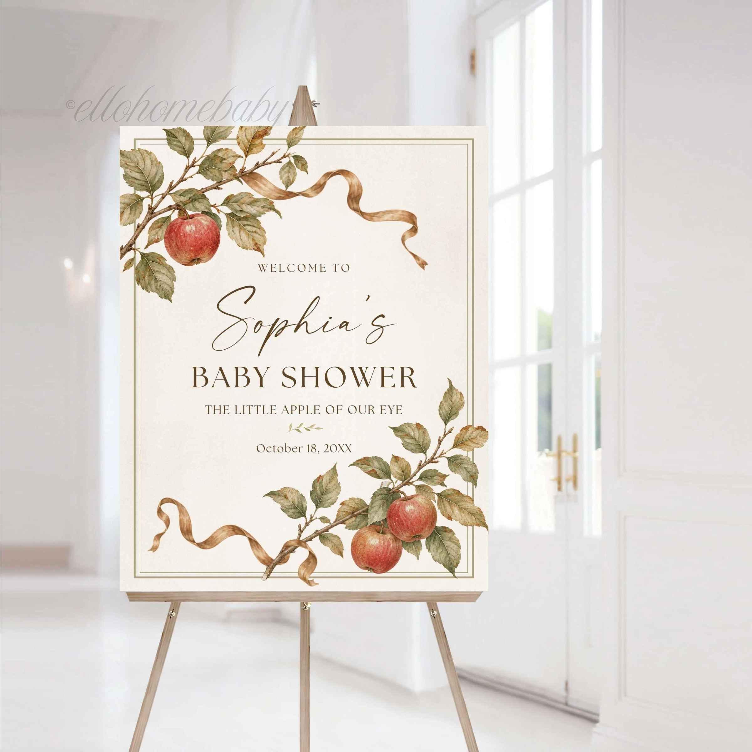 Little Apple of Our Eye Baby Shower Sign on an easel at an elegant event.